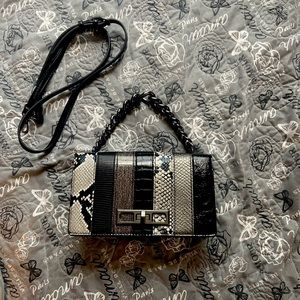Once used Aldo hand/cross body striped black and snake skin purse.